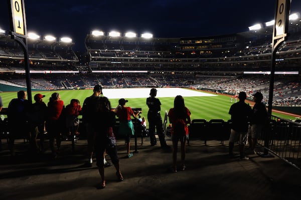 WASHINGTON, DC - JULY 06:  Fans wait out the rain delayed start of the Washington Nationals and Atlanta Braves game at Nationals Park on July 6, 2017 in Washington, DC.  (Photo by Rob Carr/Getty Images)