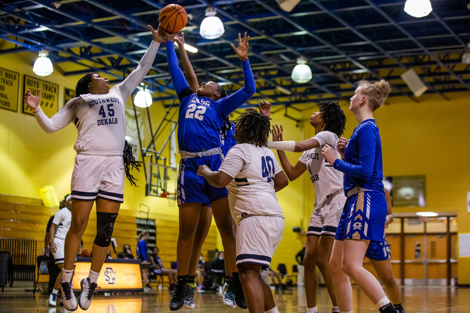 Taylor Christmas (45), center for South Dekalb High School, and Justice Bennett (22), center for Cass High School, compete for the rebound while their teammates look on during the South Dekalb vs. Cass girls basketball playoff game on Friday, February 26, 2021, at South Dekalb High School in Decatur, Georgia. South Dekalb defeated Cass 72-46. CHRISTINA MATACOTTA FOR THE ATLANTA JOURNAL-CONSTITUTION