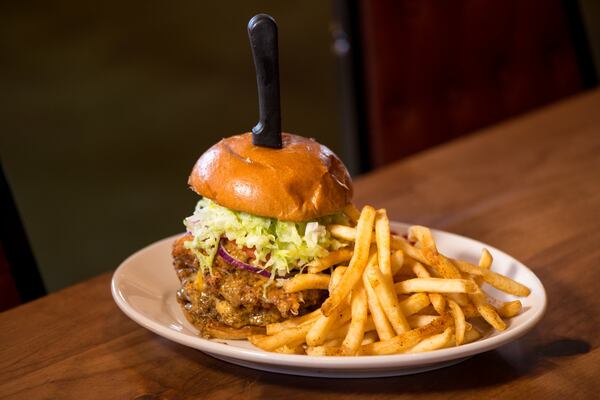 Fried Chicken Sandwich with cheese and hot honey mustard, served with lettuce tomato and onion. Photo credit- Mia Yakel.