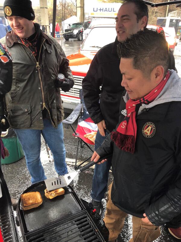 Soccer fans were cooking everything from grilled cheese to a whole hog at the tailgating on Saturday, Dec. 8, 2018, at the Gulch, where enthusiastic Atlanta United supporters gathered for hours before game time in spite of the rainy conditions. (Photo: Carrie Teegardin/AJC)