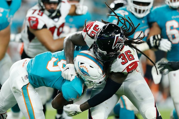 Kemal Ishmael #36 of the Atlanta Falcons tackles Mark Walton #9 of the Miami Dolphins during the first quarter of the preseason game at Hard Rock Stadium on August 08, 2019 in Miami, Florida. (Photo by Michael Reaves/Getty Images)