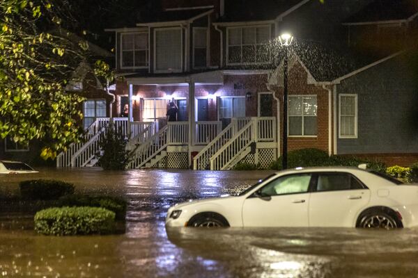 Flood waters at Peachtree Park apartments partially submerged cars when Helene entered Georgia as a Category 2 hurricane Sept. 27. It was downgraded to a tropical storm, but brought a lot of problems to Atlanta, with numerous water rescues and incessant rain. More than 1.1 million power outages were reported statewide, and flash flooding remained a major concern. (John Spink/AJC)