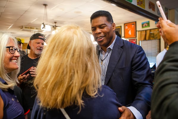 Herschel Walker meets Jan Smythe, a Roswell resident, during a meet and greet event on Wednesday, July 27, 2022, at Longstreet Cafe in Gainesville, Georgia. Fox & Friends broadcasted live from the restaurant during which co-host Brian Kilmeade interviewed Walker. CHRISTINA MATACOTTA FOR THE ATLANTA JOURNAL-CONSTITUTION.