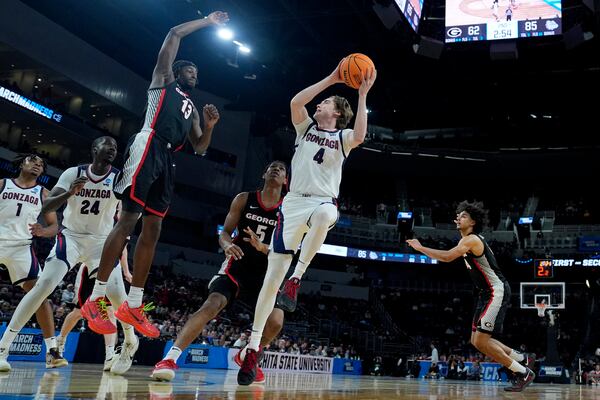 Gonzaga guard Dusty Stromer (4) gets past Georgia guard Silas Demary Jr. (5) to put up a shot during the second half of the first round of the NCAA college basketball tournament, Thursday, March 20, 2025, in Wichita, Kan. (AP Photo/Charlie Riedel)