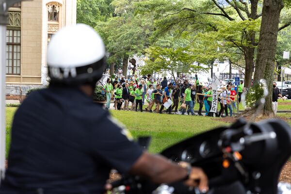 Opponents of an under-construction law enforcement training center, known to some as “Cop City,” protest at City Hall in Atlanta on Monday, September 16, 2024. It’s been one year since opponents submitted a petition to force a referendum to block the project. (Arvin Temkar / AJC)