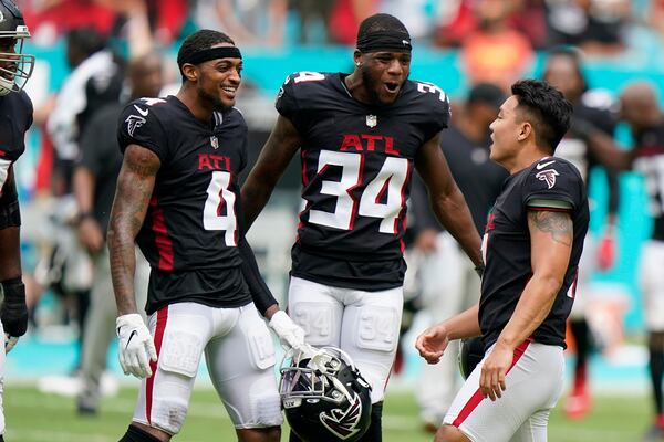 Falcons wide receiver Tajae Sharpe (4) and cornerback Darren Hall (34) congratulate kicker Younghoe Koo (7) after he kicked the game-winning field goal in the closing seconds against the Miami Dolphins, Sunday, Oct. 24, 2021, in Miami Gardens, Fla. The Falcons won 30-28. (Wilfredo Lee/AP)