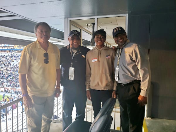 Westlake High safety Clayton Powell-Lee (third from left) poses with former Georgia Tech football players (from left) Eddie McAshan and Joe Harris and his father Gary Lee (on right) at a Yellow Jackets game at Bobby Dodd Stadium. Lee also played for the Jackets. Powell-Lee announced his commitment to play for Tech on June 20, 2021. (Photo courtesy Gary Lee)