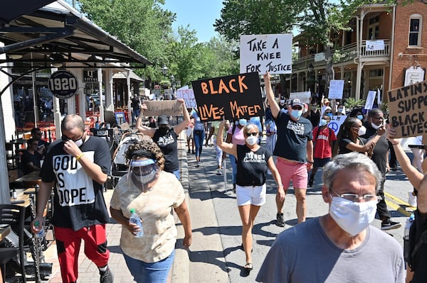 Peaceful protesters march through the downtown Roswell during a Solidarity March on Saturday, June 13, 2020. Hundreds joined Pastor Lee Jenkins and Roswell Police Chief James Conroy for a Solidarity March on Saturday, June 13 at 10 a.m. Pastor Jenkins is organizing the march to protest racism and police brutality. HYOSUB SHIN / HYOSUB.SHIN@AJC.COM