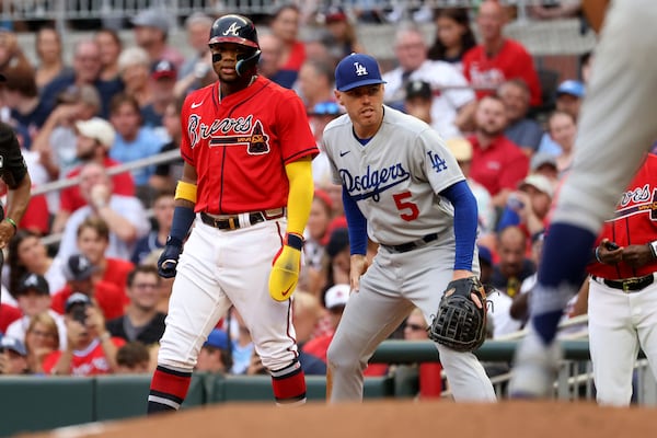 Braves right fielder Ronald Acuna, left, takes a lead next to Los Angeles Dodgers first baseman Freddie Freeman at Truist Park Friday, June 24, 2022, in Atlanta. (Jason Getz / Jason.Getz@ajc.com)