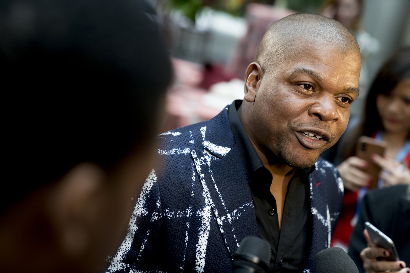 Artist Kehinde Wiley, who painted the official portrait of former President Barack Obama, speaks to members of the media following an official unveiling ceremony at the Smithsonian's National Portrait Gallery. (AP Photo/Andrew Harnik)