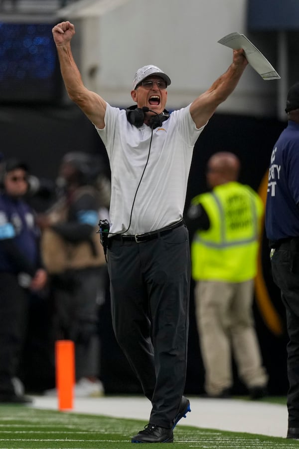 Los Angeles Chargers head coach Jim Harbaugh celebrates on the sideline during the first half of an NFL football game against the Tennessee Titans, Sunday, Nov. 10, 2024, in Inglewood, Calif. (AP Photo/Mark J. Terrill)