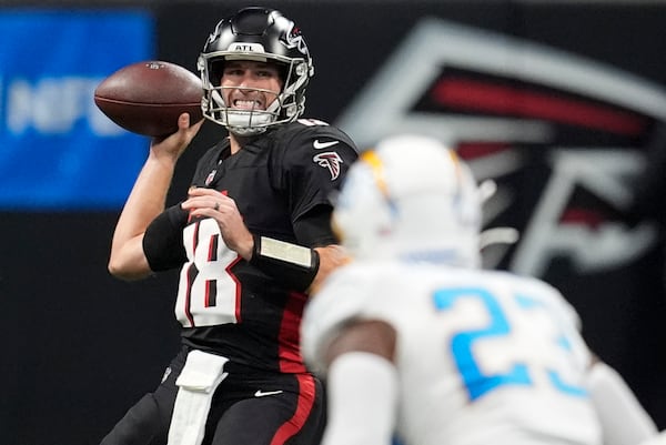 Atlanta Falcons quarterback Kirk Cousins (18) passes during the second half of an NFL football game against the Los Angeles Chargers on Sunday, Dec. 1, 2024 in Atlanta. (AP Photo/Mike Stewart)