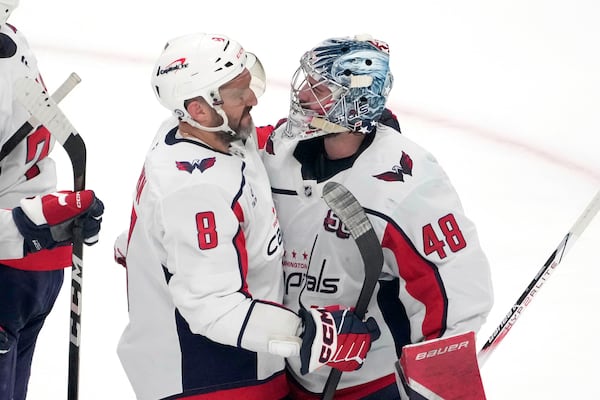 Washington Capitals' Alex Ovechkin (8) congratulates goaltender Logan Thompson (48) after a victory over the San Jose Sharks in an NHL hockey game in San Jose, Calif., Saturday, March 15, 2025. (AP Photo/Tony Avelar)