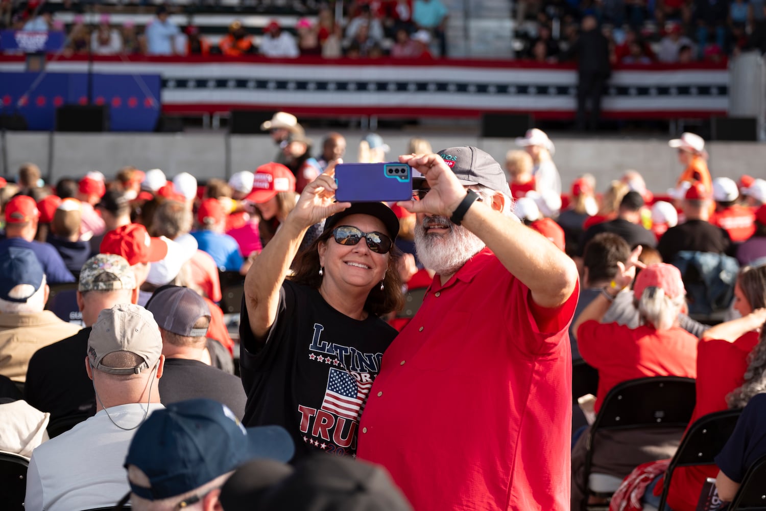 Aggie and Rafael Garcia, from Satellite Beach, Fla., take a selfie before the start of a rally for former President Donald Trump in Macon on Sunday, Nov. 3, 2024.   Ben Gray for the Atlanta Journal-Constitution