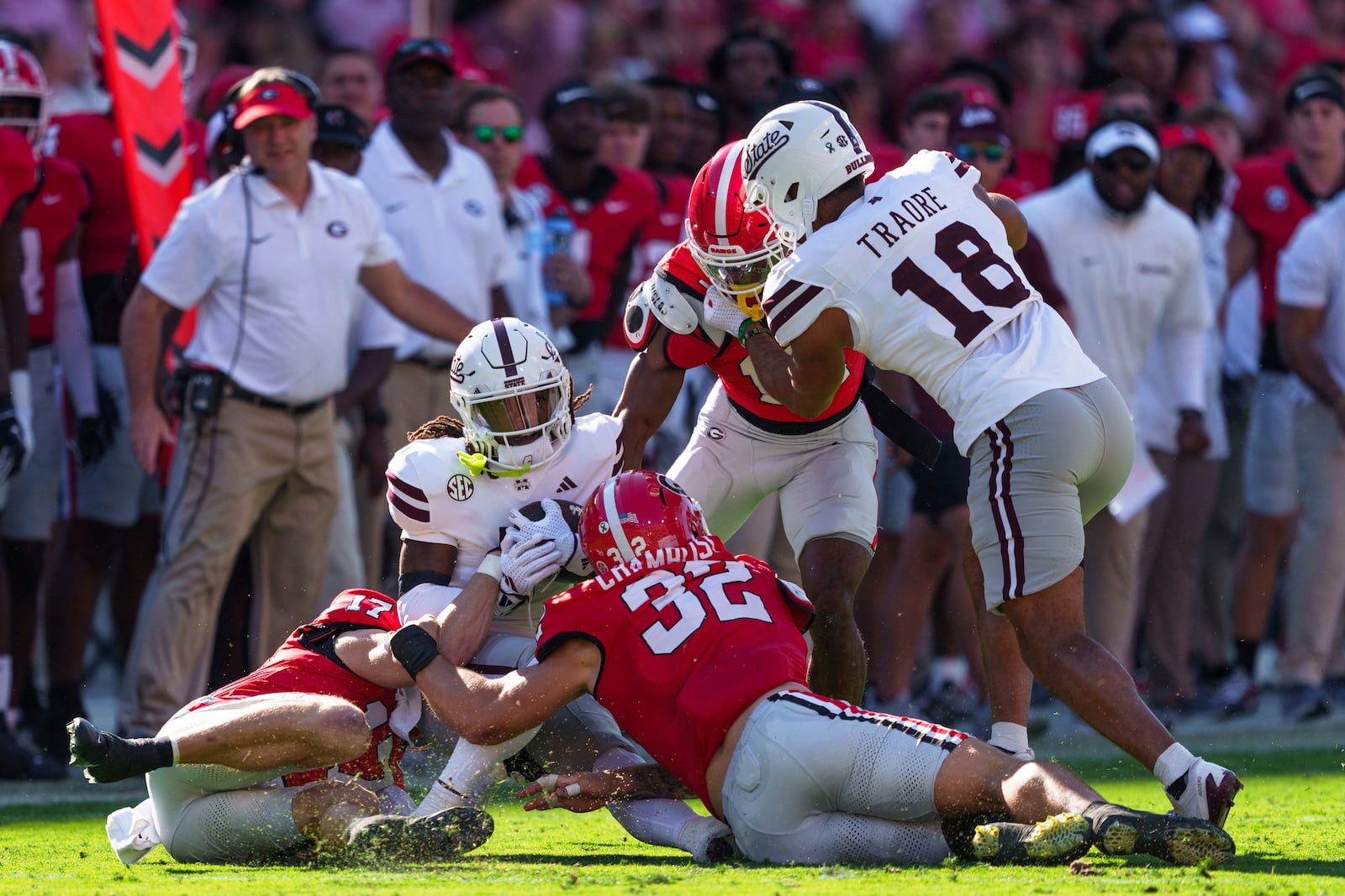 Mississippi State wide receiver Mario Craver (7) is tackled by Georgia linebacker Chaz Chambliss (32) and defensive back Dan Jackson (17) during an NCAA college football game, Saturday, Oct. 12, 2024, in Athens, Ga. (AP Photo/Jason Allen)