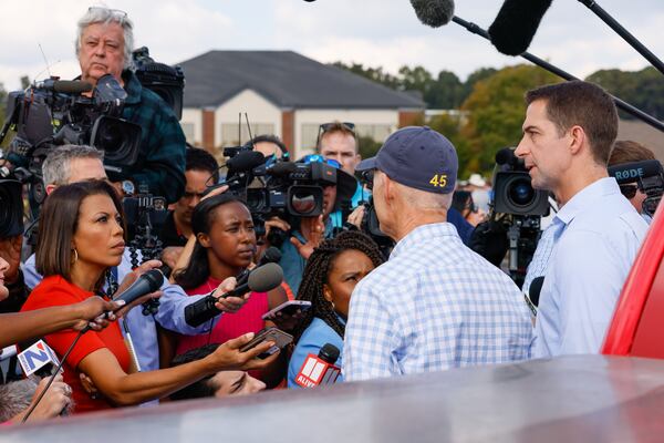 Florida U.S. Sen. Rick Scott, in ballcap, and Arkansas U.S. Sen. Tom Cotton speak to the media at a rally in Carrollton for Republican U.S. Senate hopeful Herschel Walker. (Arvin Temkar / arvin.temkar@ajc.com)