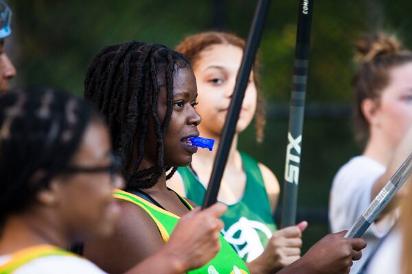 Natajha Graham listens to a teammate speak during half-time of the Spelman College lacrosse game on Sunday, October 23, 2022, at Hammond Park in Sandy Springs, Georgia. Several girls on the Spelman team said that joining the lacrosse team was the first time they felt a part of something on campus. CHRISTINA MATACOTTA FOR THE ATLANTA JOURNAL-CONSTITUTION.