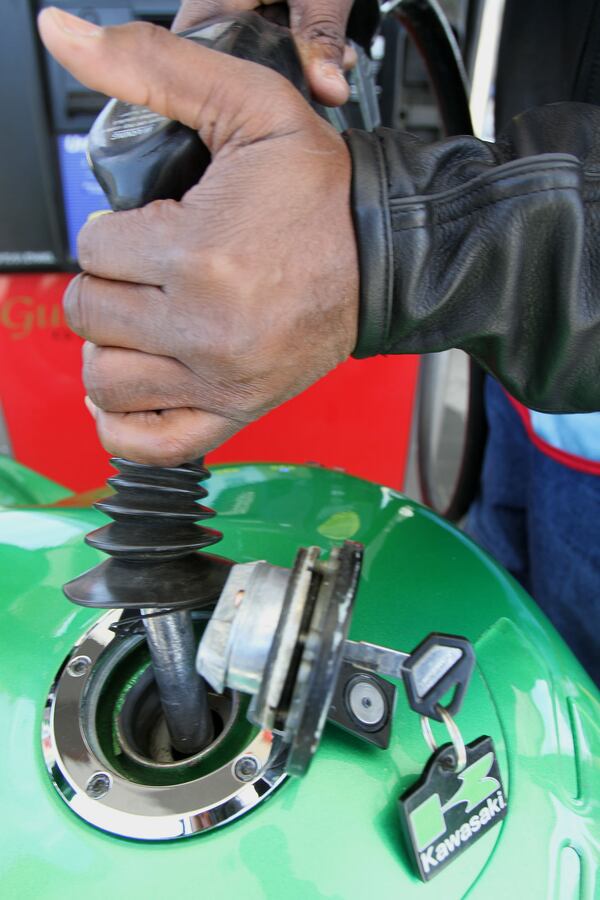 Robert Taylor fuels up his motorcycle at the QT gas station in Doraville Wednesday, April 13, 2011. Vino Wong vwong@ajc.com