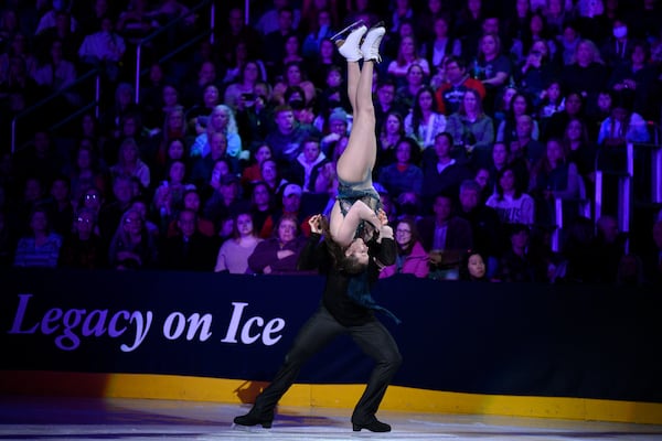 Christina Carreira, front, and Anthony Ponomarenko, back, perform Sunday, March 2, 2025, in Washington at the Legacy on Ice event, a figure skating tribute to support the families and loved ones affected by the tragic Jan. 29, 2025, aviation incident. (AP Photo/Nick Wass)