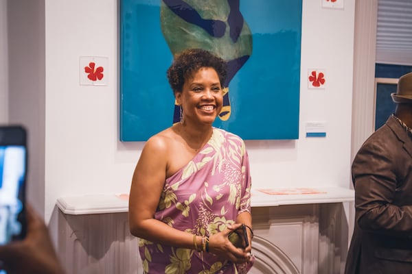 Murrell in front of one of her paintings at Hammonds House (Photo by Nyeusi Mwezi)