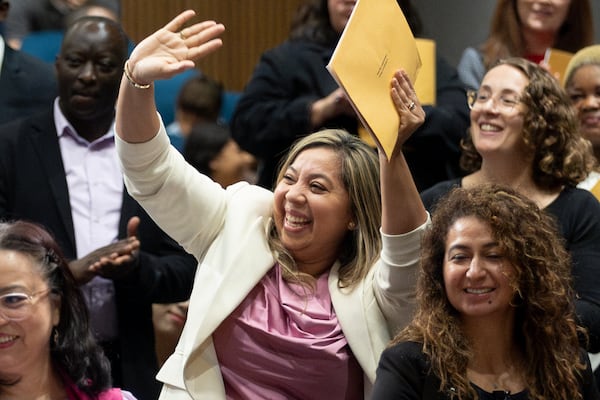 Some of the 150 participants stand and celebrate when their country is being called during the Naturalization ceremony at the Gwinnett Justice Administration Center Tuesday July 2 2024. (Steve Schaefer / AJC)