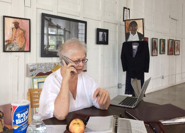 Anita Beaty, head of the Peachtree-Pine homeless shelter, does a little business in the art gallery/office at the front of the massive building. Photo by Bill Torpy