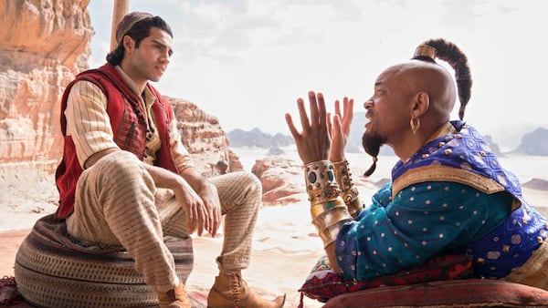 Will Smith (right) portrays the Genie as Mena Massoud (left) stars as Aladdin in the Disney live-action remake of the cartoon classic "Aladdin."