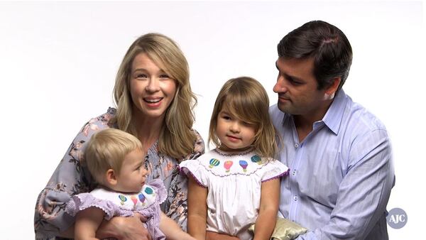 Jenn Hobby, Star 94.1 radio host, with husband Grant Rivera, superintendent of Marietta City Schools, and daughters, Lauren, who is 4, and Reese, 18 months old. Hobby said one of the hardest things about being a mother is limited time. “Because I want to work really hard, and do a great job at my job, and I want to do a really great job raising them, and I want to be a really great wife, but there is only a certain amount of hours in the day,” she said. RYON HORNE / RYON.HORNE@AJC.COM