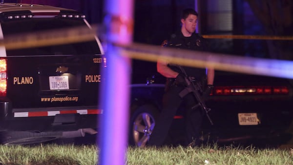 A policeman carries a rifle Sunday, Sept. 10, 2017, outside the scene of a mass shooting at a home in Plano, Texas. Spencer Hight, 32, killed his estranged wife and seven friends at her home before being shot and killed by responding officers.