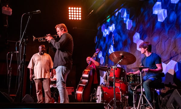 Venkman's in the Fourth Ward is home to Joe Gransden's Jazz Jam every Wednesday where many of Atlanta's jazz greats gather to watch and to participate.  Eric Moore, left, jams on vocals is with Joe Gransden on trumpet and 21-year-old Holden Carson, right, on drums Wednesday, July 13, 2022. (Jenni Girtman for The Atlanta Journal-Constitution)