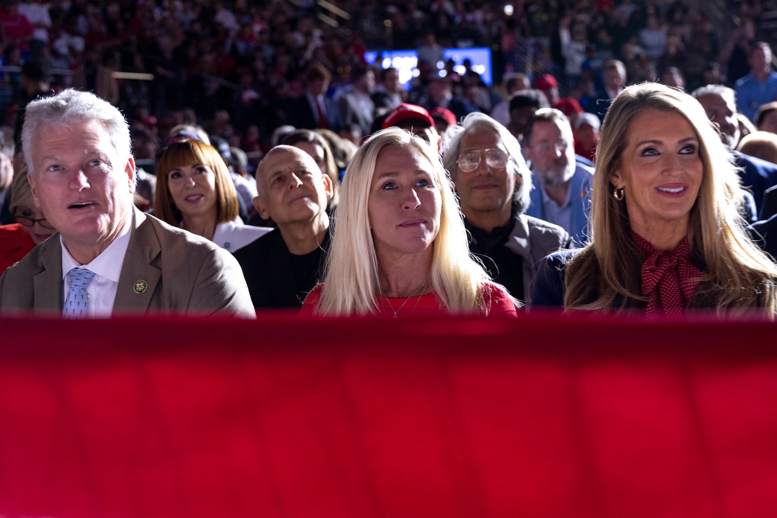 (Left to right): U.S. Reps. Mike Collins of Jackson and Marjorie Taylor Greene of Rome listen to former President Donald Trump alongside former U.S. Sen. Kelly Loeffler at a rally in Atlanta on Monday.