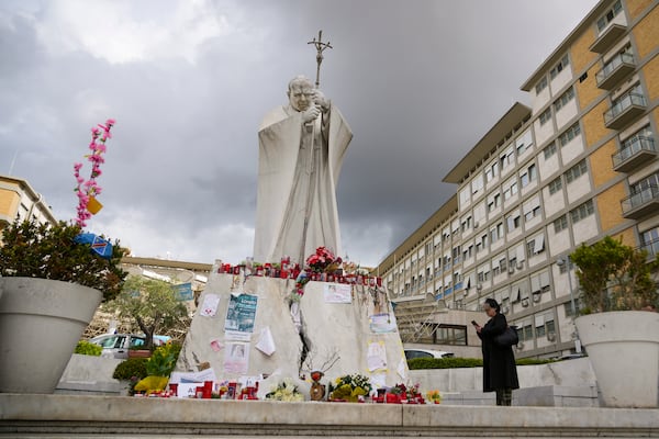 People pray for Pope Francis in front of the Agostino Gemelli Polyclinic, in Rome, Thursday, March 13, 2025, where he is hospitalized since Friday, Feb. 14. (AP Photo/Andrew Medichini)