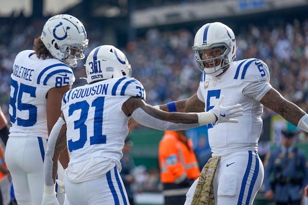 Indianapolis Colts quarterback Anthony Richardson (5) celebrates with running back Tyler Goodson (31) and tight end Drew Ogletree (85) after scoring a touchdown against the New York Jets during the second quarter of an NFL football game, Sunday, Nov. 17, 2024, in East Rutherford, N.J. (AP Photo/Seth Wenig)