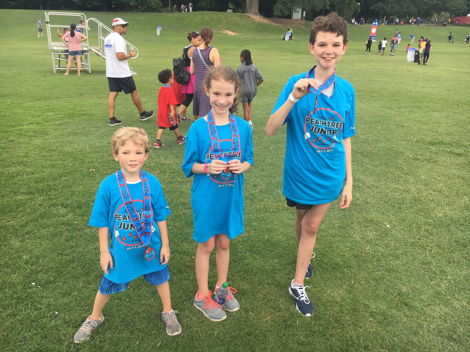 Audrey Woodall, right, age 12 poses after running the Anthem Peachtree Junior on Wednesday, July 3, 2019. (Ben Brasch/AJC)