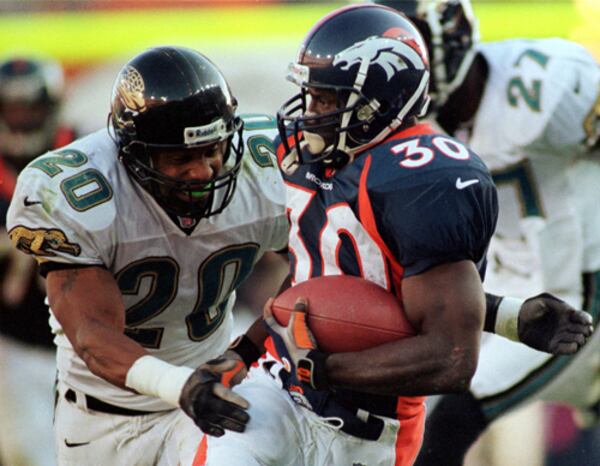 Denver Broncos running back Terrell Davis grinds out the yardage as Jacksonville Jaguars Donovin Darius (20) moves in to make the tackle during the second quarter of action at Mile High Stadium in Denver on Sunday, Oct. 25, 1998. Davis passed the 1,000 yard mark for the season with his performace Sunday. (AP Photo/Bryan Kelsen) Denver Broncos running back Terrell Davis grinds out the yardage as Jacksonville Jaguars Donovin Darius (20) moves in to make the tackle during the second quarter of action at Mile High Stadium in Denver on Sunday, Oct. 25, 1998. Davis passed the 1,000 yard mark for the season with his performace Sunday. (AP Photo/Bryan Kelsen)