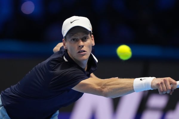 Italy's Jannik Sinner returns the ball to United States' Taylor Fritz during their singles tennis match of the ATP World Tour Finals at the Inalpi Arena, in Turin, Italy, Tuesday, Nov. 12, 2024. (AP Photo/Antonio Calanni)