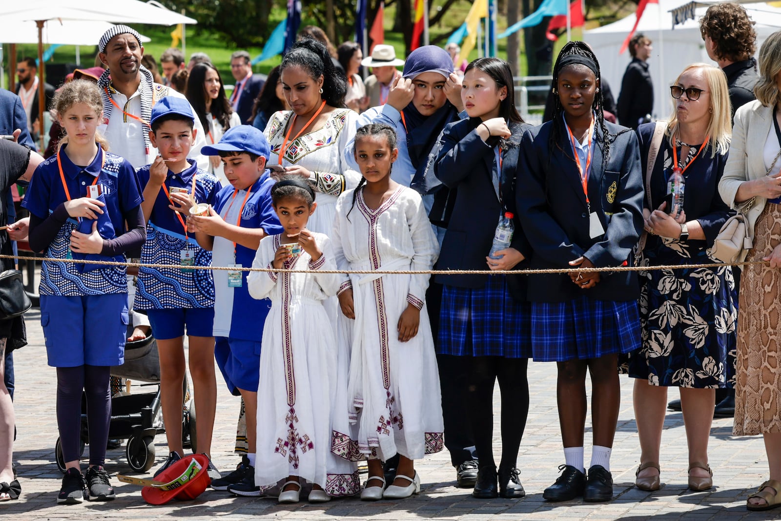 Members of the public wait for Britain's King Charles III and Queen Camilla to arrive to attend the Premier's Community BBQ on Tuesday Oct. 22, 2024 in Sydney, Australia. (Brook Mitchell/Pool Photo via AP)