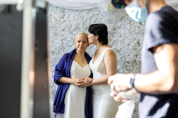 (L-R) Maria Del Rosario Garibay Campos and Rachel Lynn Craig take a photo at a photo booth after getting married in Courtroom 9G of the Fulton County Courthouse in Atlanta on Valentine’s Day, Tuesday, February 14, 2023. (Arvin Temkar / arvin.temkar@ajc.com)