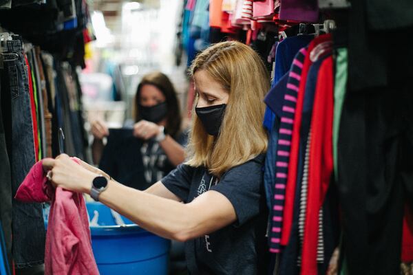 Amanda Roper (foreground) and Jennifer Farmer sort clothes at Foster Care Support Foundation in Roswell. This year's “generosity” campaign by North Point Ministries raised more than $7 million and church attendees put in in excess of 27,000 volunteers hours at local and global nonprofits. Contributed photo