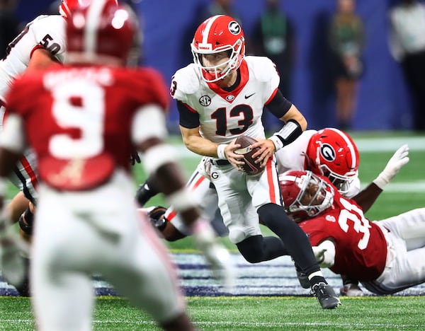 120421 Atlanta: Georgia quarterback Stetson Bennett is flushed from the pocket and runs for yardage on a quarterback keeper against Alabama in the SEC Championship game on Saturday, Dec 4, 2021, in Atlanta.   “Curtis Compton / Curtis.Compton@ajc.com”`