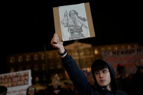 A protester takes part in a rally, after the Greek opposition parties have challenged the country's center-right government with a censure motion in parliament over a devastating rail disaster nearly two years ago, in Athens, Wednesday, March 5, 2025. (AP Photo/Petros Giannakouris)