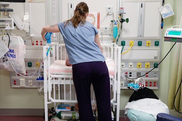 Jessica Bullock, a nurse in the newborn intensive care unit at Children’s Healthcare of Atlanta Egleston cares for a newborn in October 2023. (Natrice Miller/AJC)