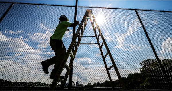 Alexander Gutierrez with Paul Wiley Electrical works on the new tennis courts on Tuesday, August 28, 2018  will be opening at the Bitsy Grant Tennis Center in Atlanta.