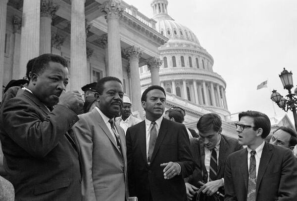 Civil rights leader Rev. Ralph Abernathy, second from left, discusses the second day of the Poor People's Campaign in Washington from the steps of the Capitol, April 30, 1968. With him are A.D. King, left, brother of the late Dr. Martin Luther King,