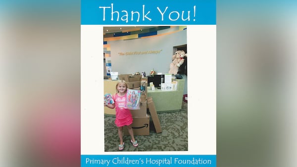 Katelyn Lunt, 6, poses with the toys she ordered on Amazon after donating them to Primary Children's Hospital in Salt Lake City, Utah.