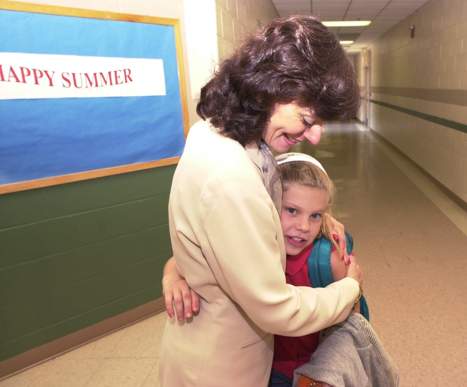 Original caption: "June 2, 2000, was the final day of school many metro area schools, the City of Marietta school system included and on Friday afternoon at Dunleith Elementary School school principal Emily Lembeck was getting a lot of hugs, maybe more than usual, because next school year Lembeck moves on up in rank to become the principal at Marietta Middle School. Here Lembeck, left, gets a nice hug from Tabitha Cochran, 10, just before the end of school."