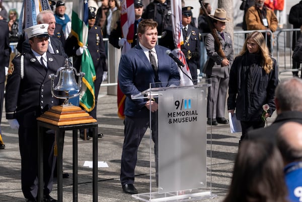 Stephen Rossili, grandchild of deceased Stephen Knapp, reads the names of those who died during a ceremony marking the anniversary of the 1993 World Trade Center bombing at the 9/11 Memorial, Wednesday, Feb. 26, 2025, in New York. (AP Photo/John Minchillo)