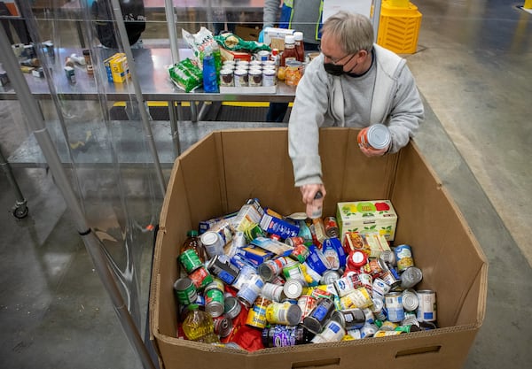 Volunteer Mike Dziadik helps to sort food at the Atlanta Community Food Bank Thursday, 23, 2021.    STEVE SCHAEFER FOR THE ATLANTA JOURNAL-CONSTITUTION