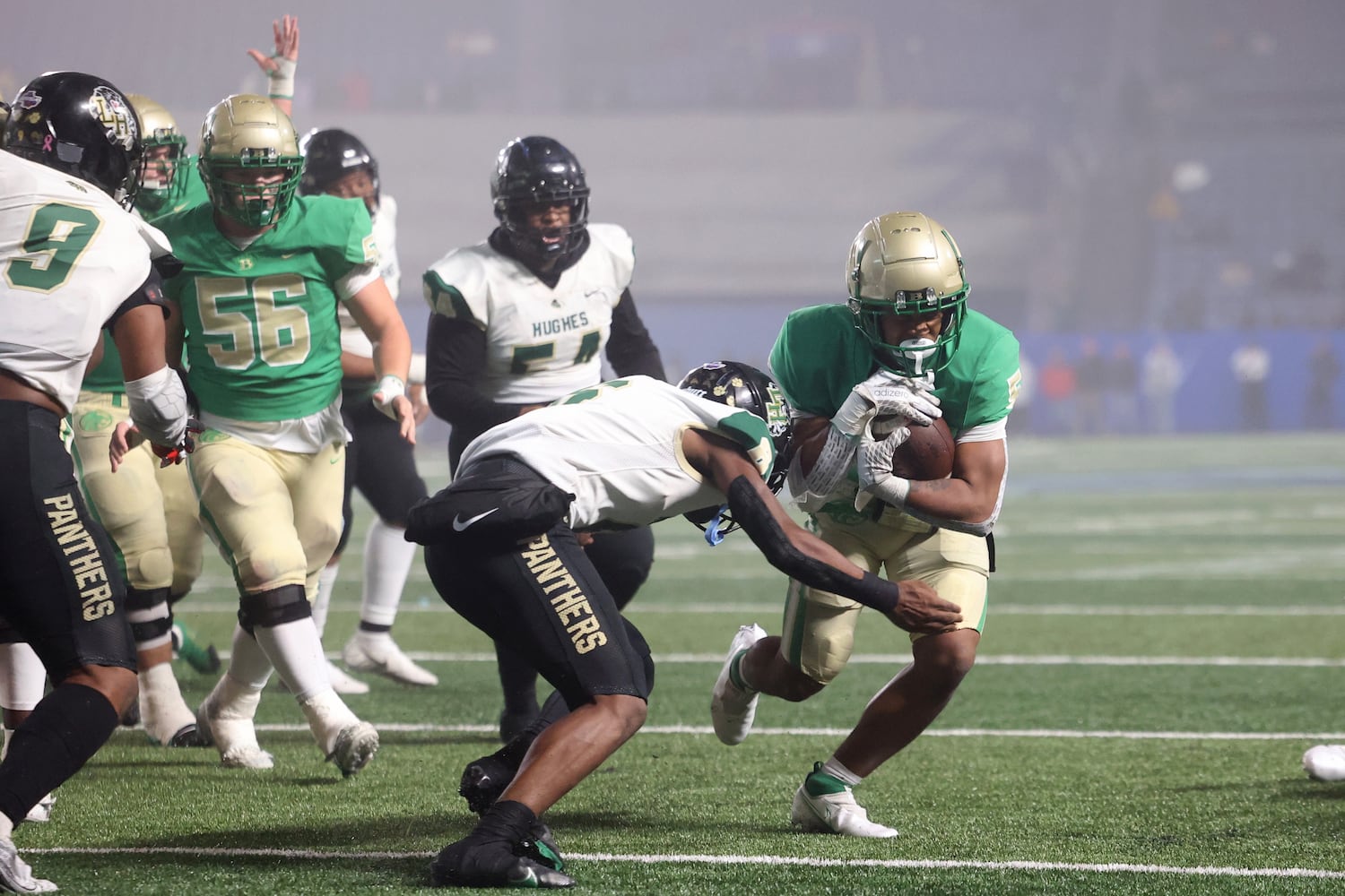 Buford running back CJ Clinkscales (5) scores a touchdown against Langston Hughes defensive back Rodney Shelley (6) during the first half of the Class 6A state title football game at Georgia State Center Parc Stadium Friday, December 10, 2021, Atlanta. JASON GETZ FOR THE ATLANTA JOURNAL-CONSTITUTION