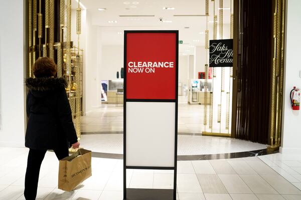 A shopper enters Saks Fifth Avenue, Canada at a Hudson's Bay in Toronto, Monday, March 17, 2025. (Christopher Katsarov/The Canadian Press via AP)